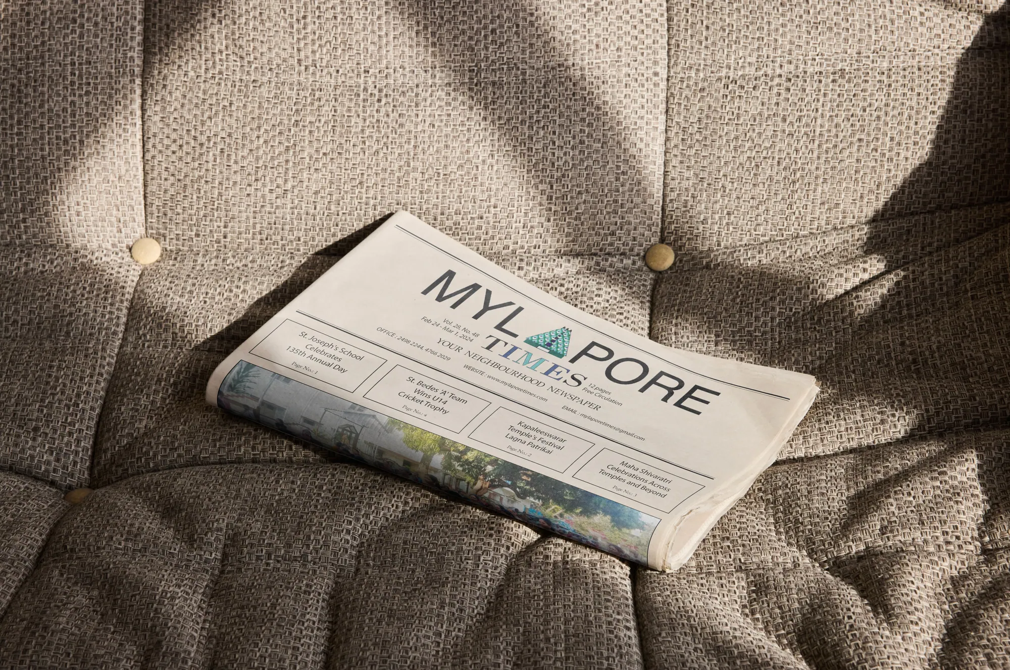 Folded Mylapore Times newspaper on a sofa