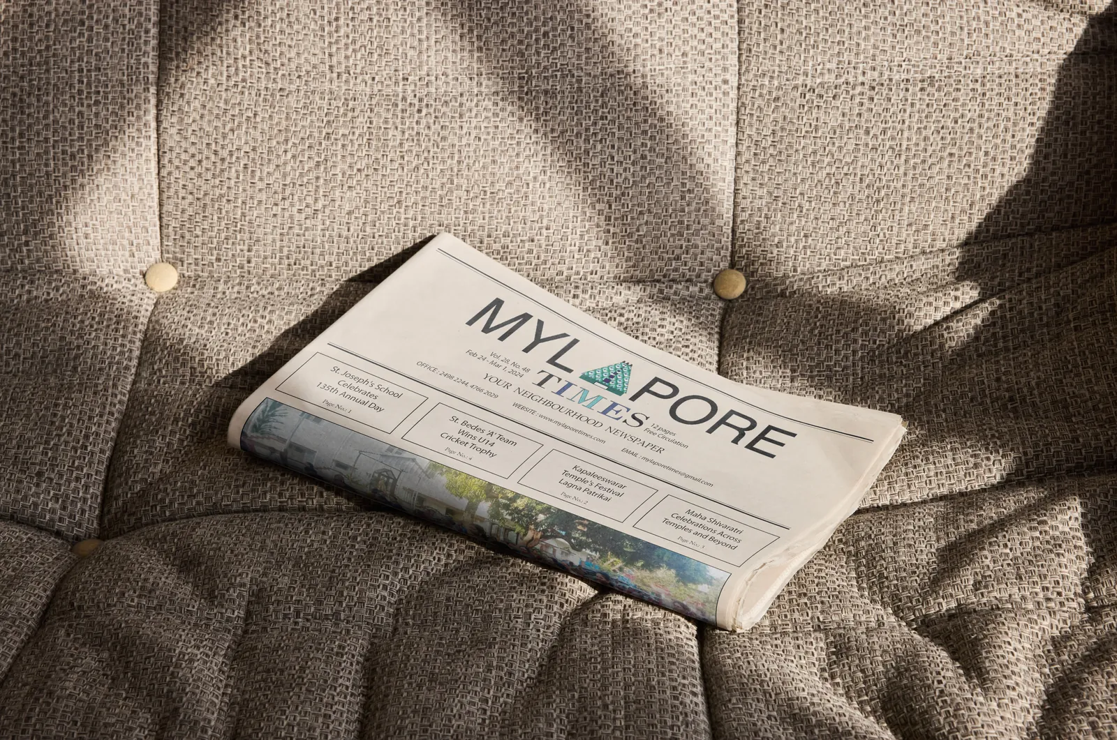 Folded Mylapore Times newspaper on a sofa